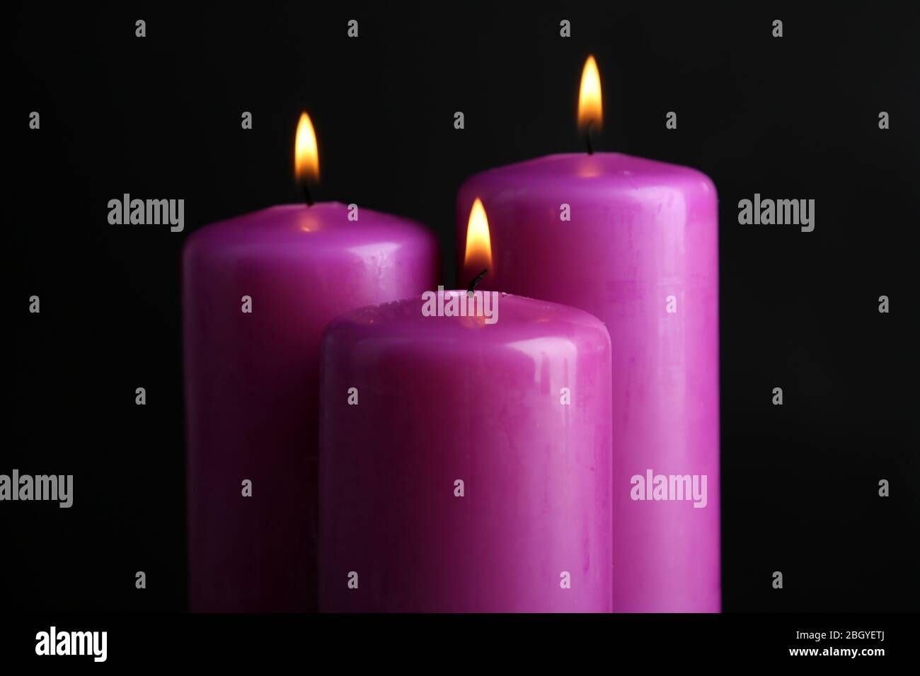 Purple candles on black background Stock Photo Alamy