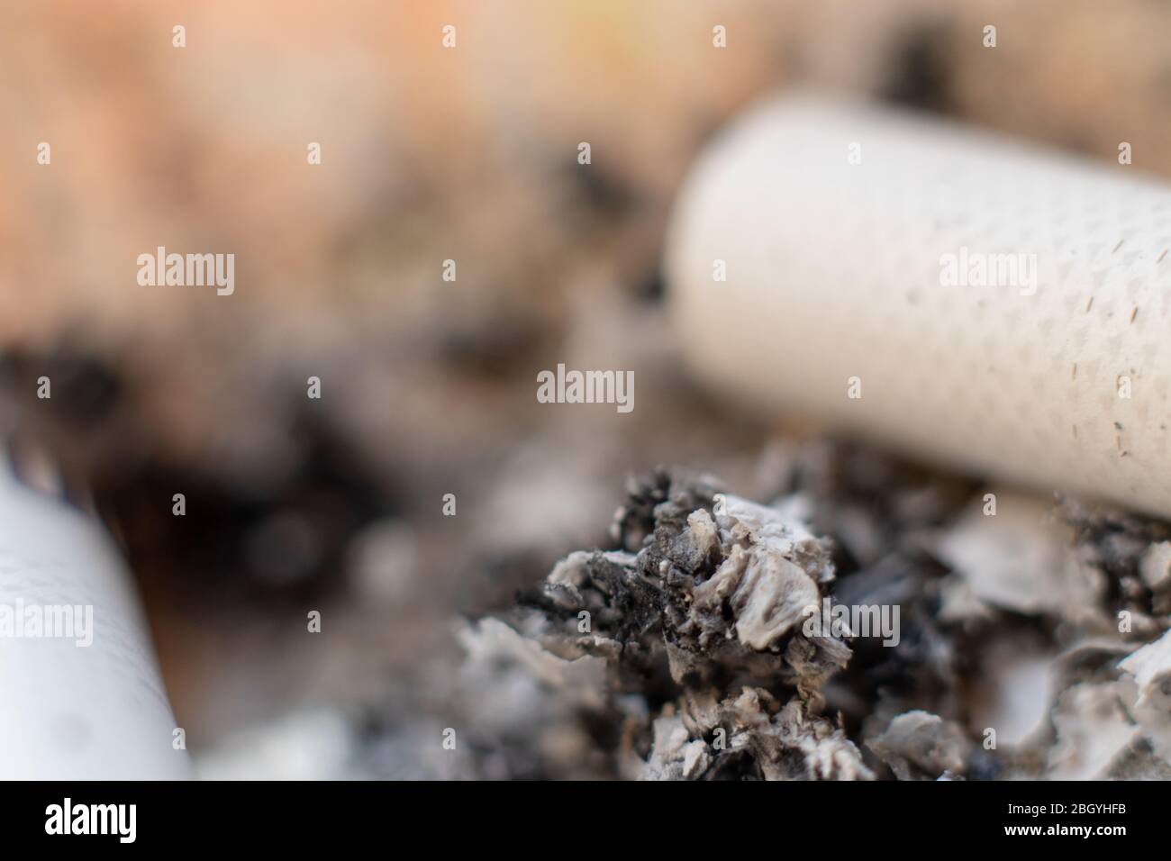Macro closeup of burnt ash from cigarettes. Bad unhealthy smoking habit
