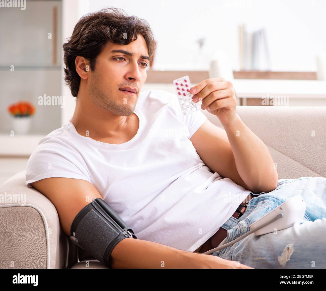 The young man measuring blood pressure at home Stock Photo - Alamy
