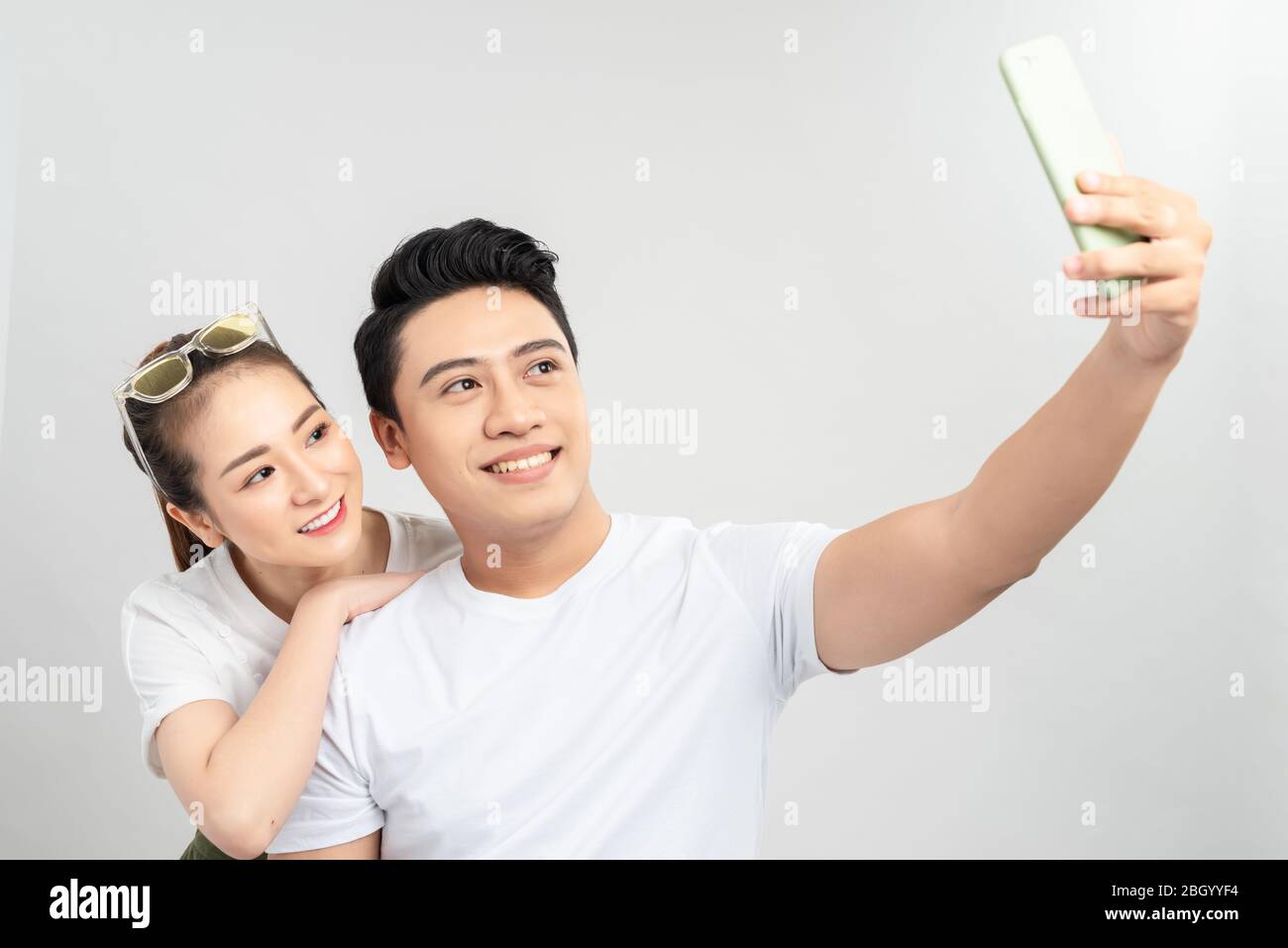 selective focus of happy asian couple taking selfie on smartphone ...