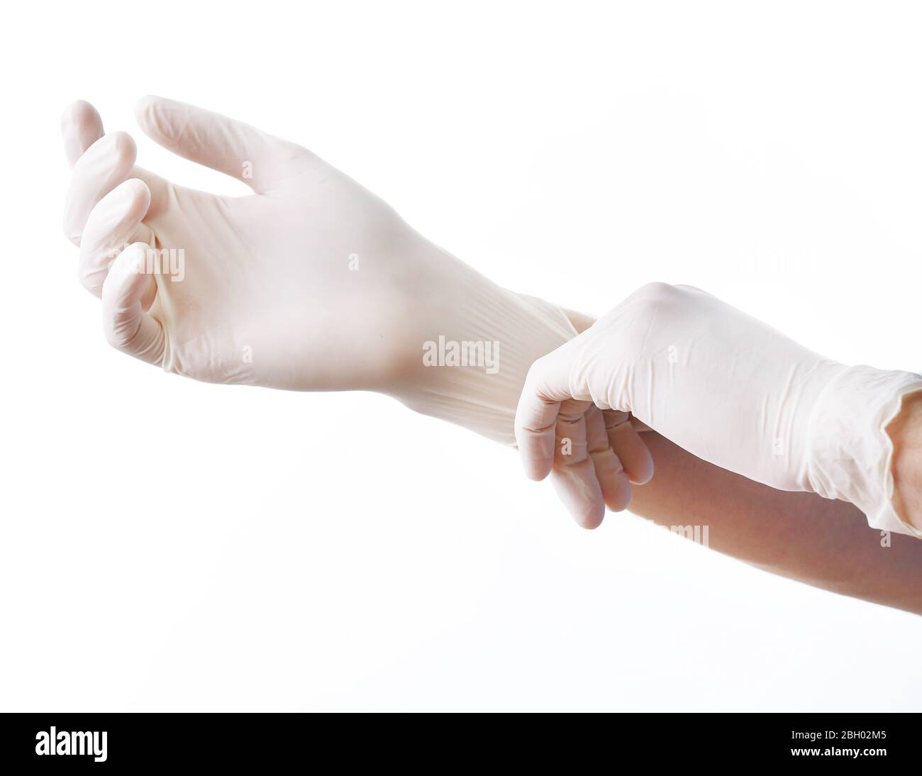 Doctor putting on sterile gloves isolated on white Stock Photo Alamy