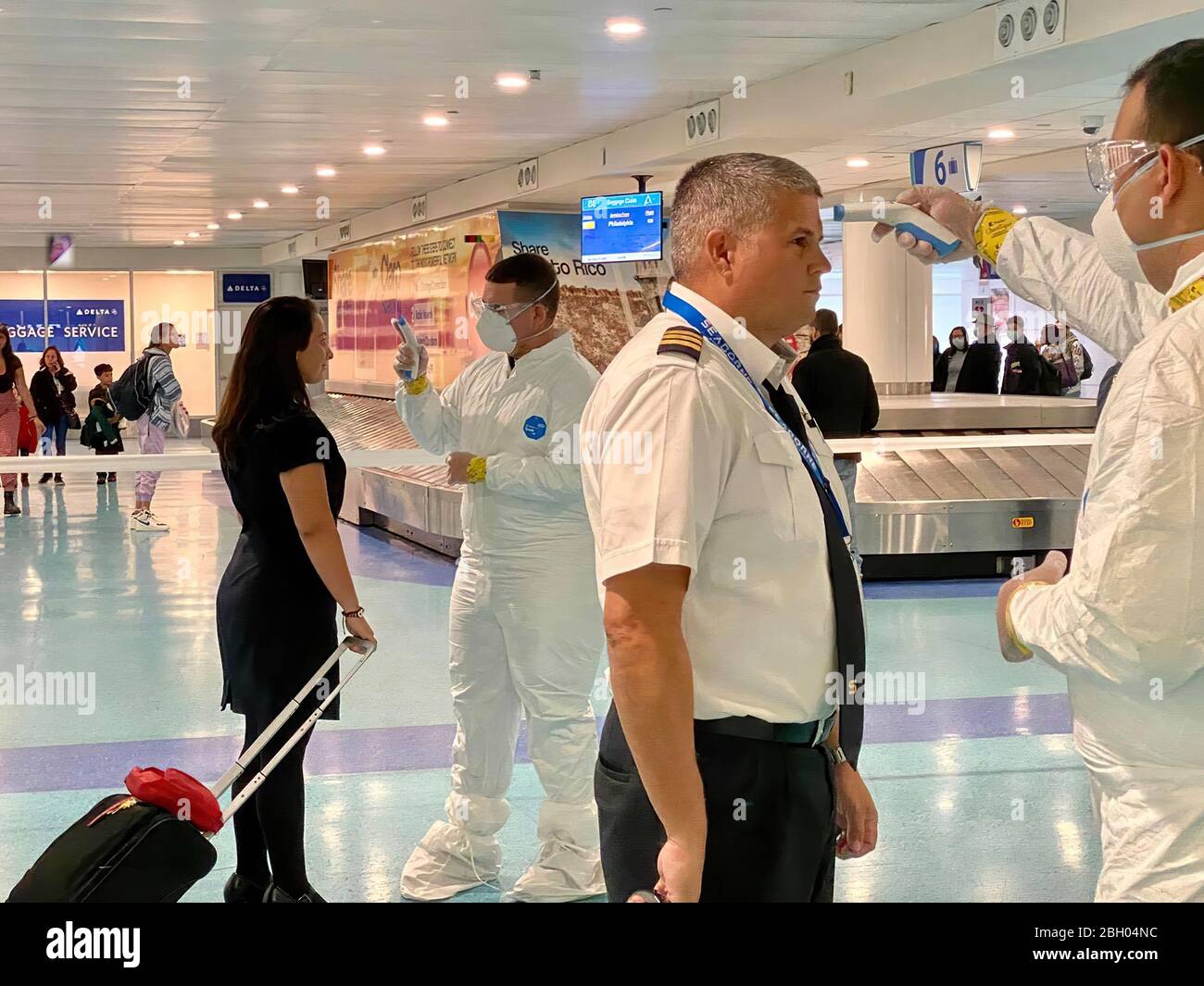 An airline pilot and a flight attendant are checked for fever at an