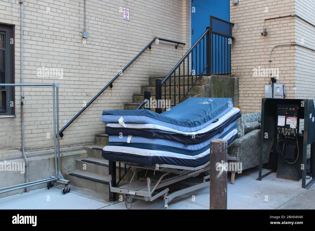 New York, New York, USA. 22nd Apr, 2020. These medical mattresses have been stacked at the bottom of a staircase in the backyard of the Plaza Rehabilitation and Nursing Center in Bronx, New York City. 3425 residents of New York state nursing homes including 554 in Bronx have died so far because of COVID-19. That represents nearly 25% of the state's pandemic deaths. Credit: Marie Le Ble/ZUMA Wire/Alamy Live News Stock Photo