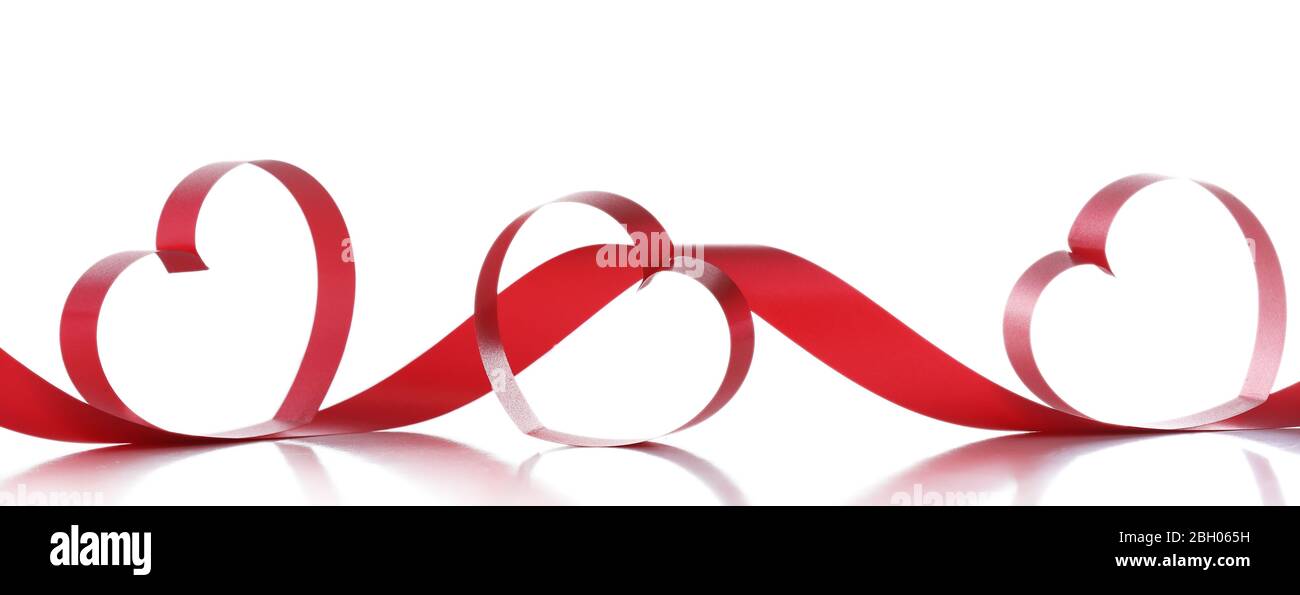 Red ribbons in shape of hearts isolated on white Stock Photo - Alamy