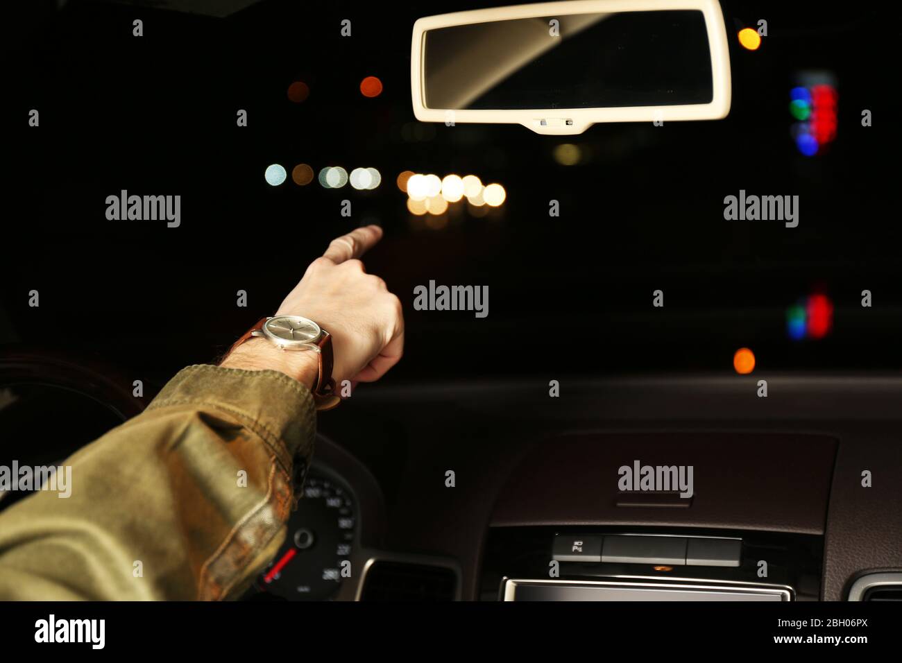 Man driving his modern car at night in city, close-up Stock Photo - Alamy