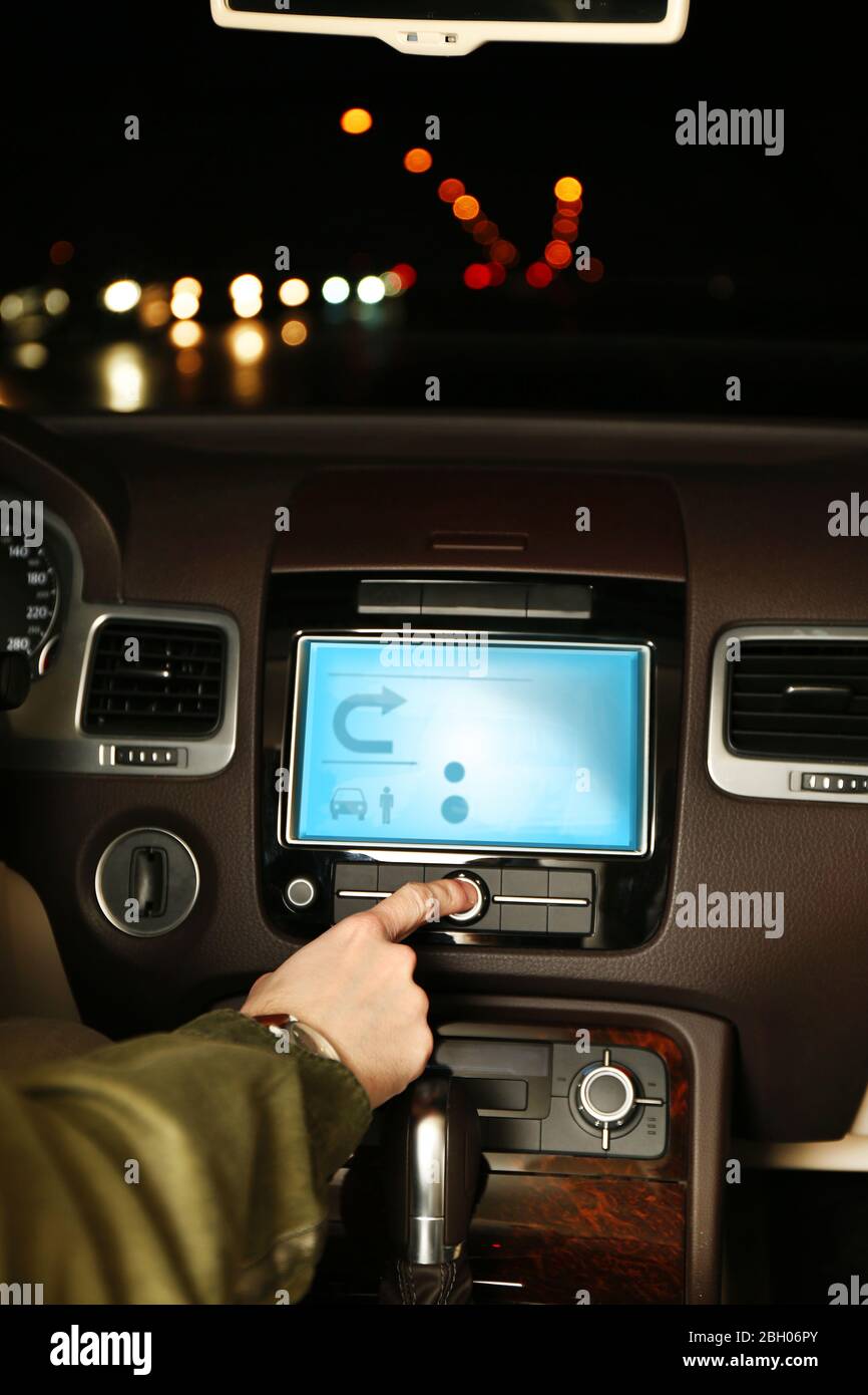 Man driving his modern car at night in city, close-up Stock Photo - Alamy