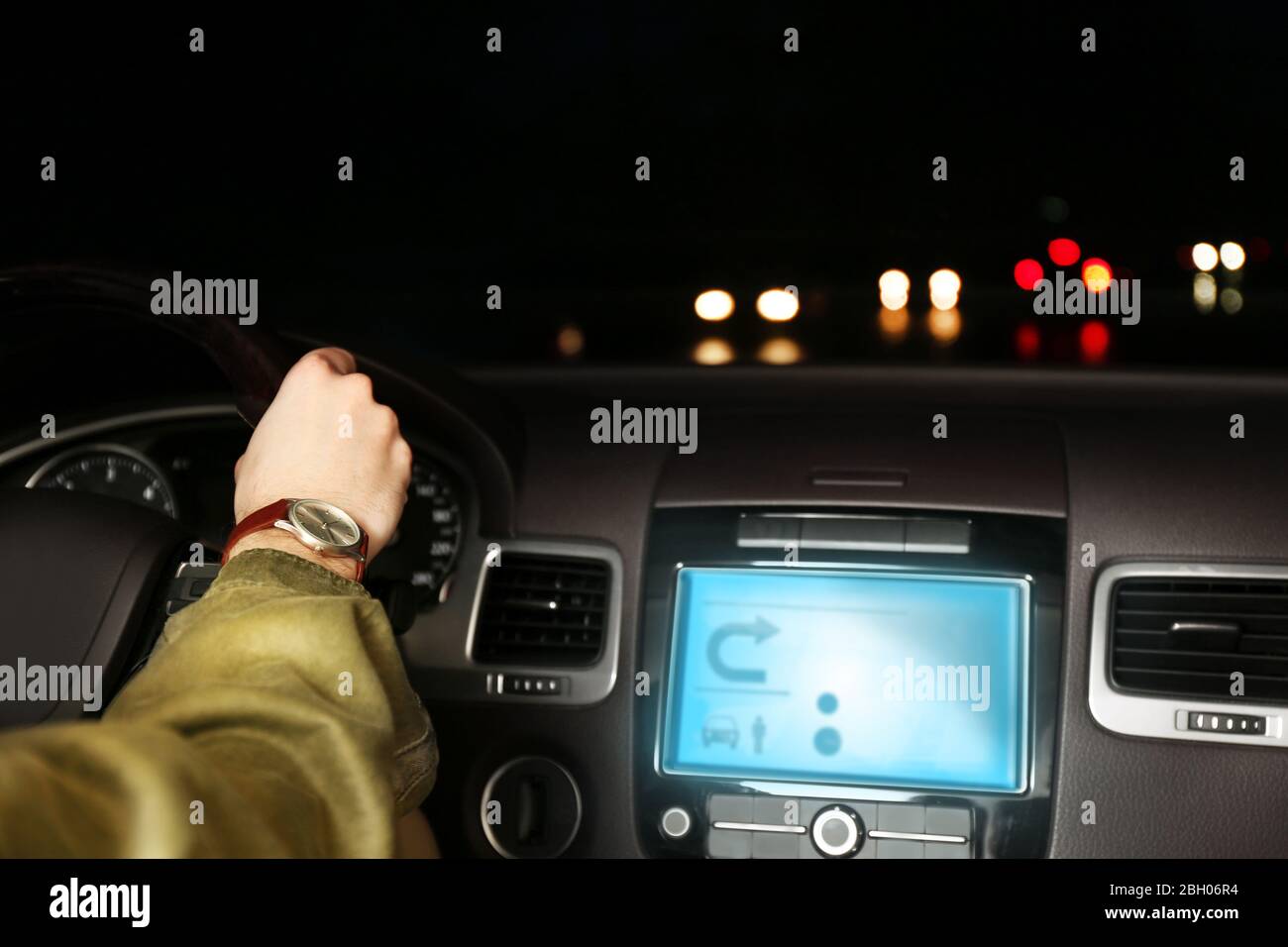Man driving his modern car at night in city, close-up Stock Photo - Alamy