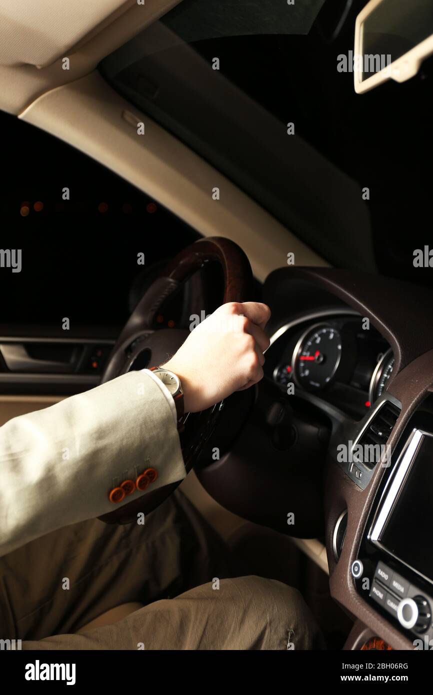 Man driving his modern car at night in city, close-up Stock Photo - Alamy