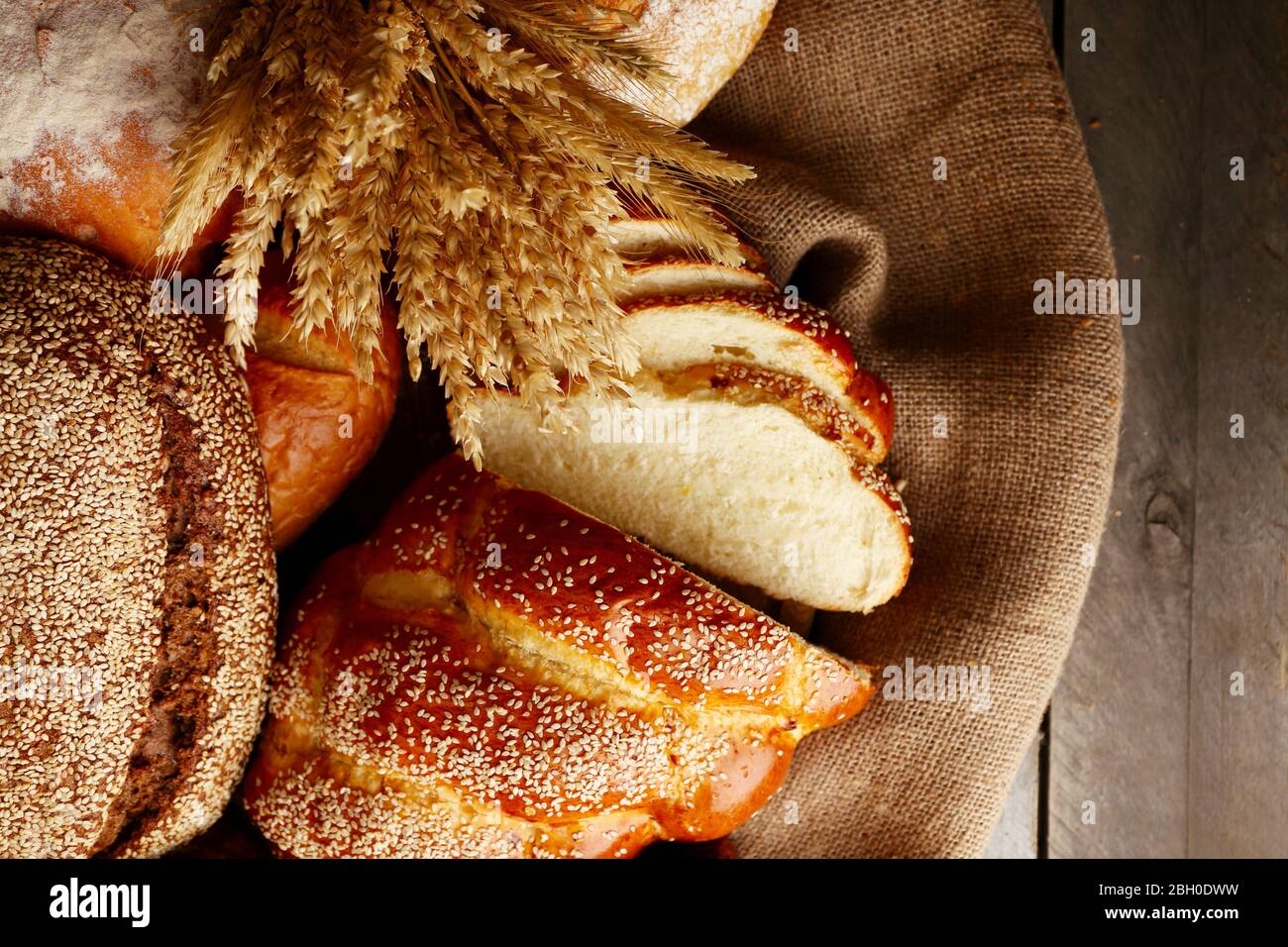 Different bread with ears on sackcloth background Stock Photo Alamy