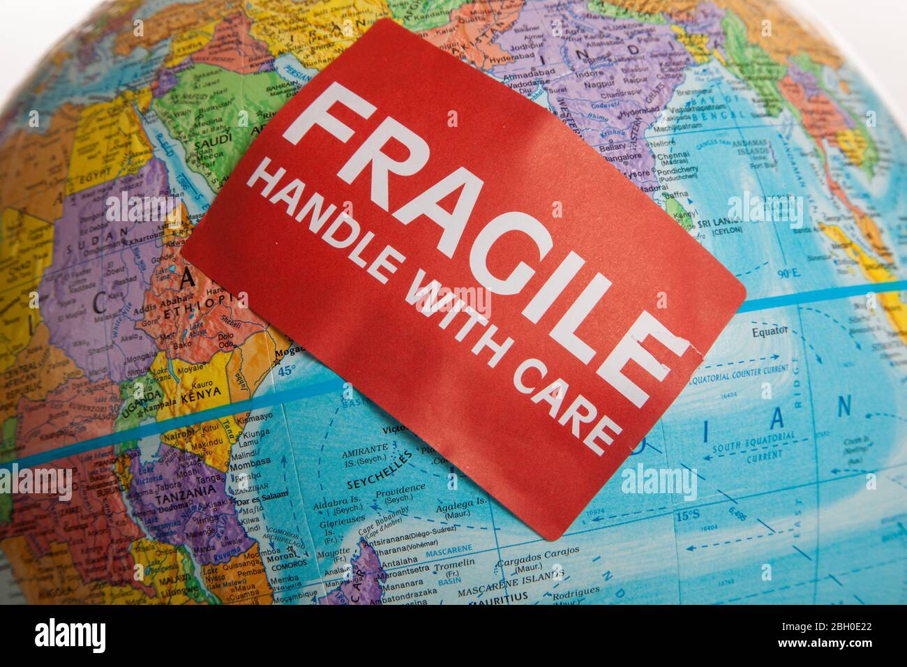 An Earth globe with a fragile hand with care sticker Stock Photo