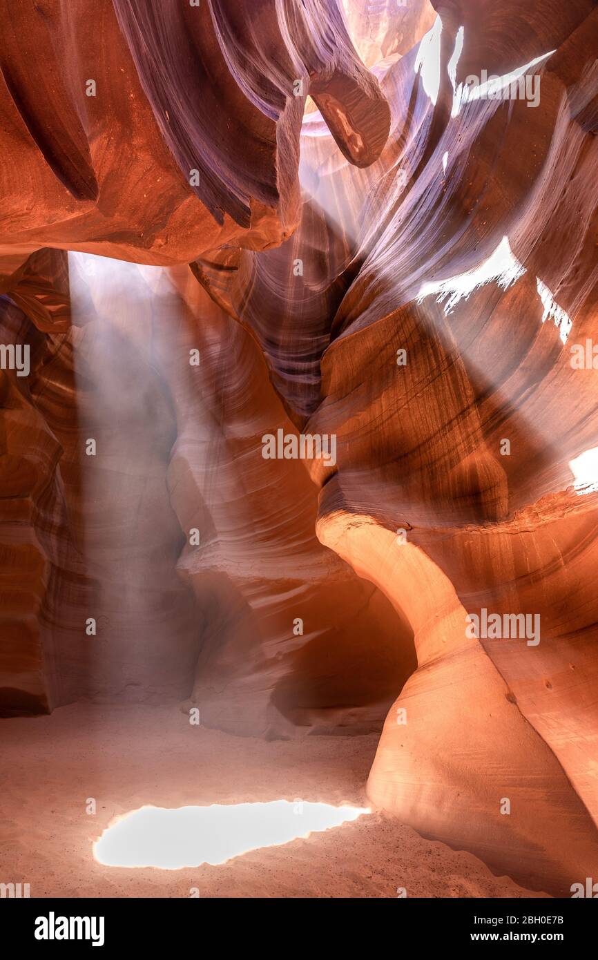 Interior of the Antelope Canyon, with two beams of sun light shining through an opening in the vault Stock Photo