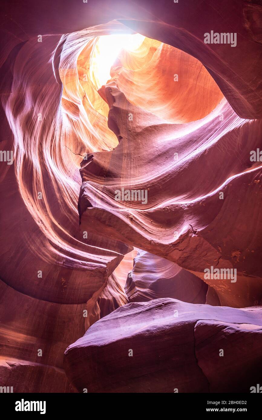 The vault of the Antelope Canyon, with an opening letting sun shine through Stock Photo