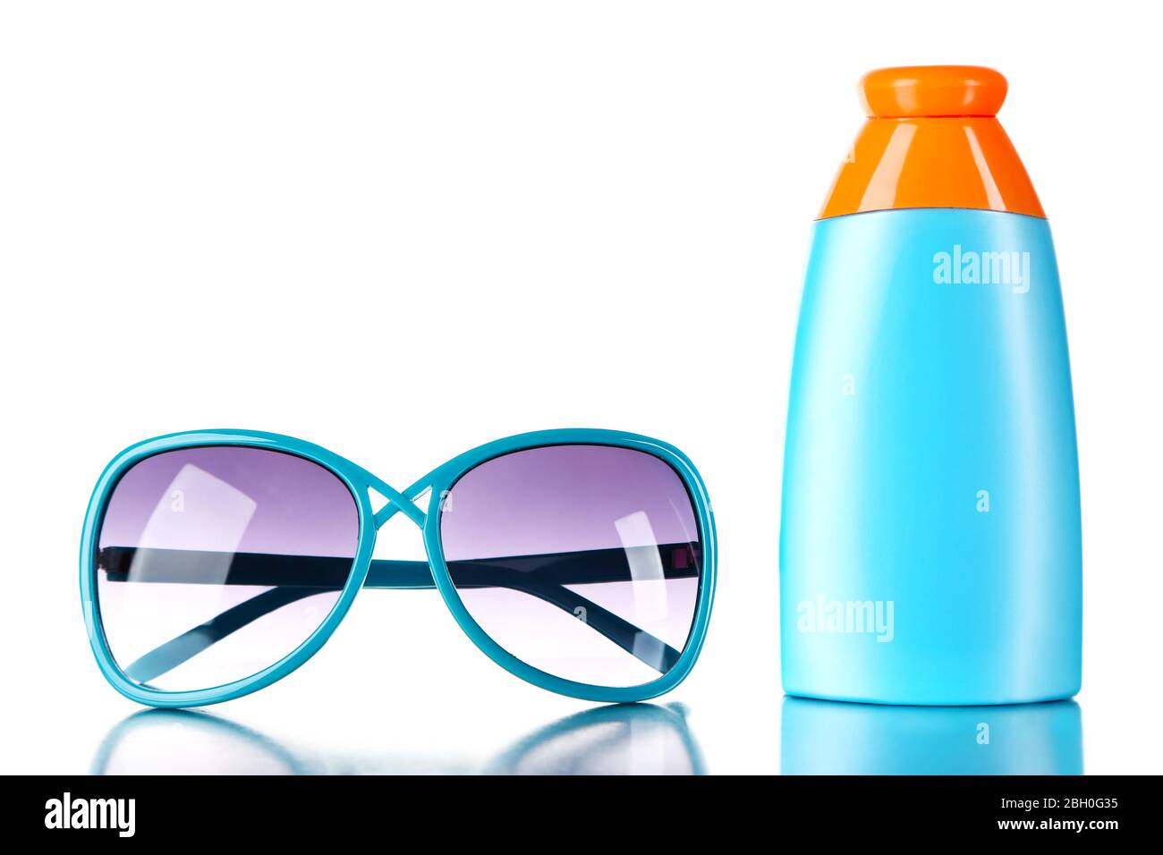 Bottle of suntan cream with sunglasses isolated on white Stock Photo