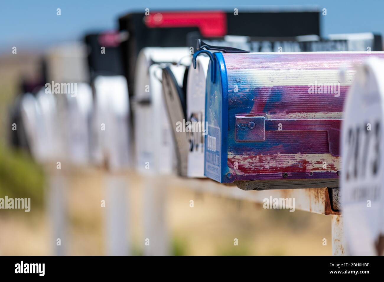 Close up of a row of iconic traditional American letterboxes, against a desertic landscape Stock Photo