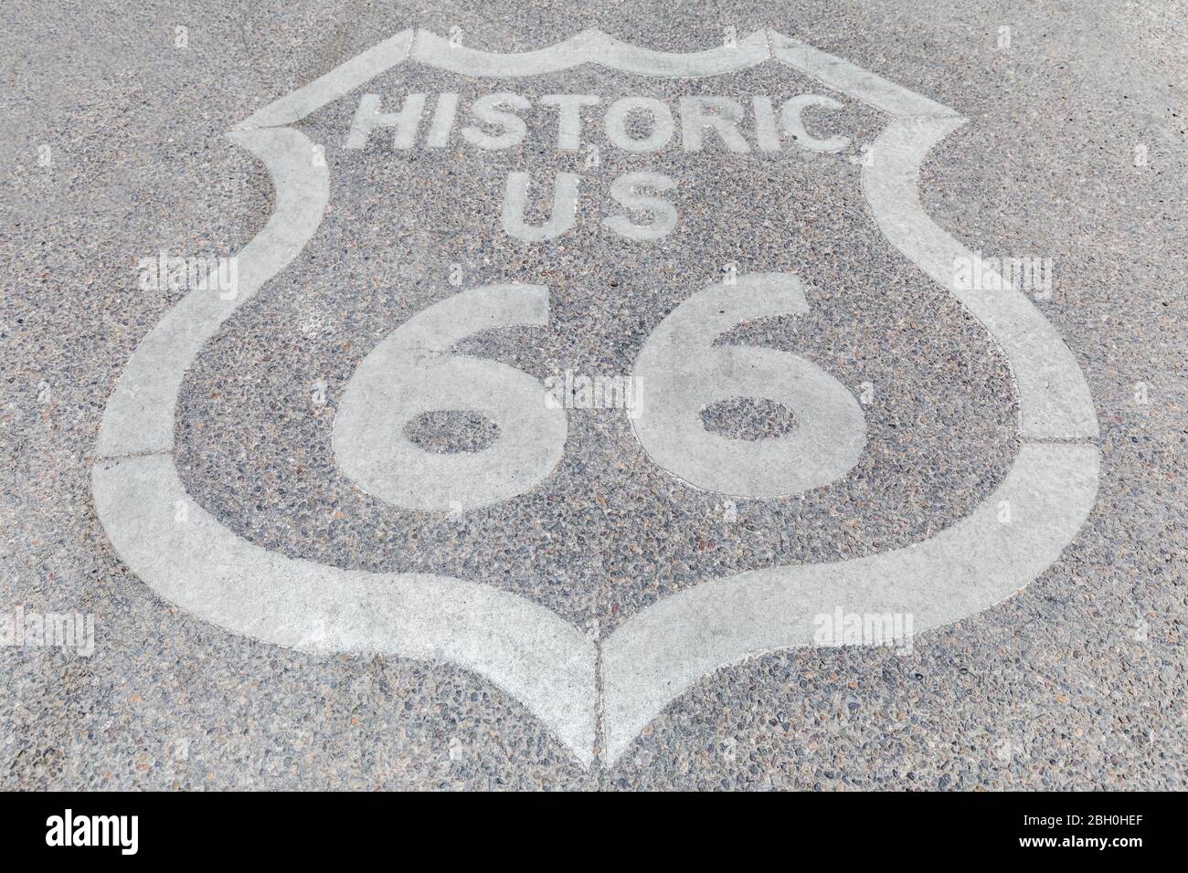 Symmetrical close up of an iconic white Historic Route 66 badge painted on the asphalt Stock Photo