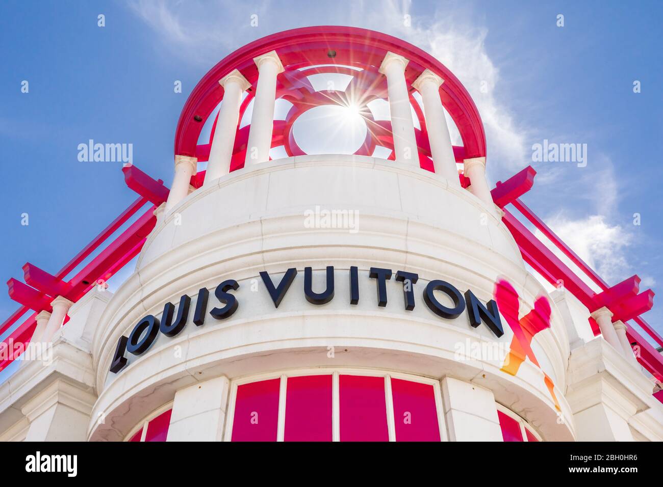 Symmetrical close up of the Louis Vuitton boutique in Rodeo Drive in Los Angeles, in a sunny summer day against a blue sky Stock Photo