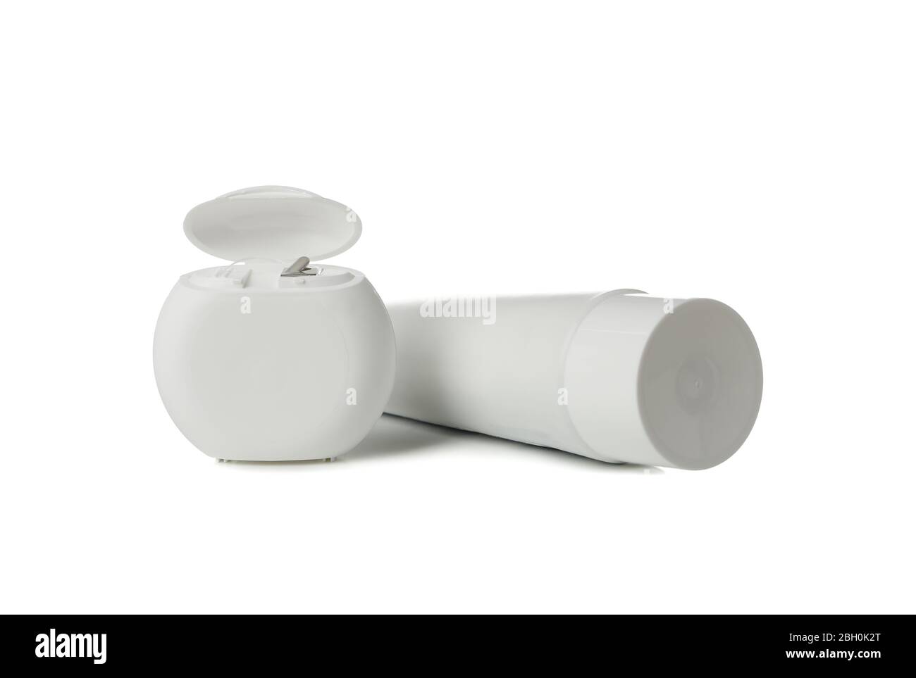 Dental floss and toothpaste isolated on white background Stock Photo