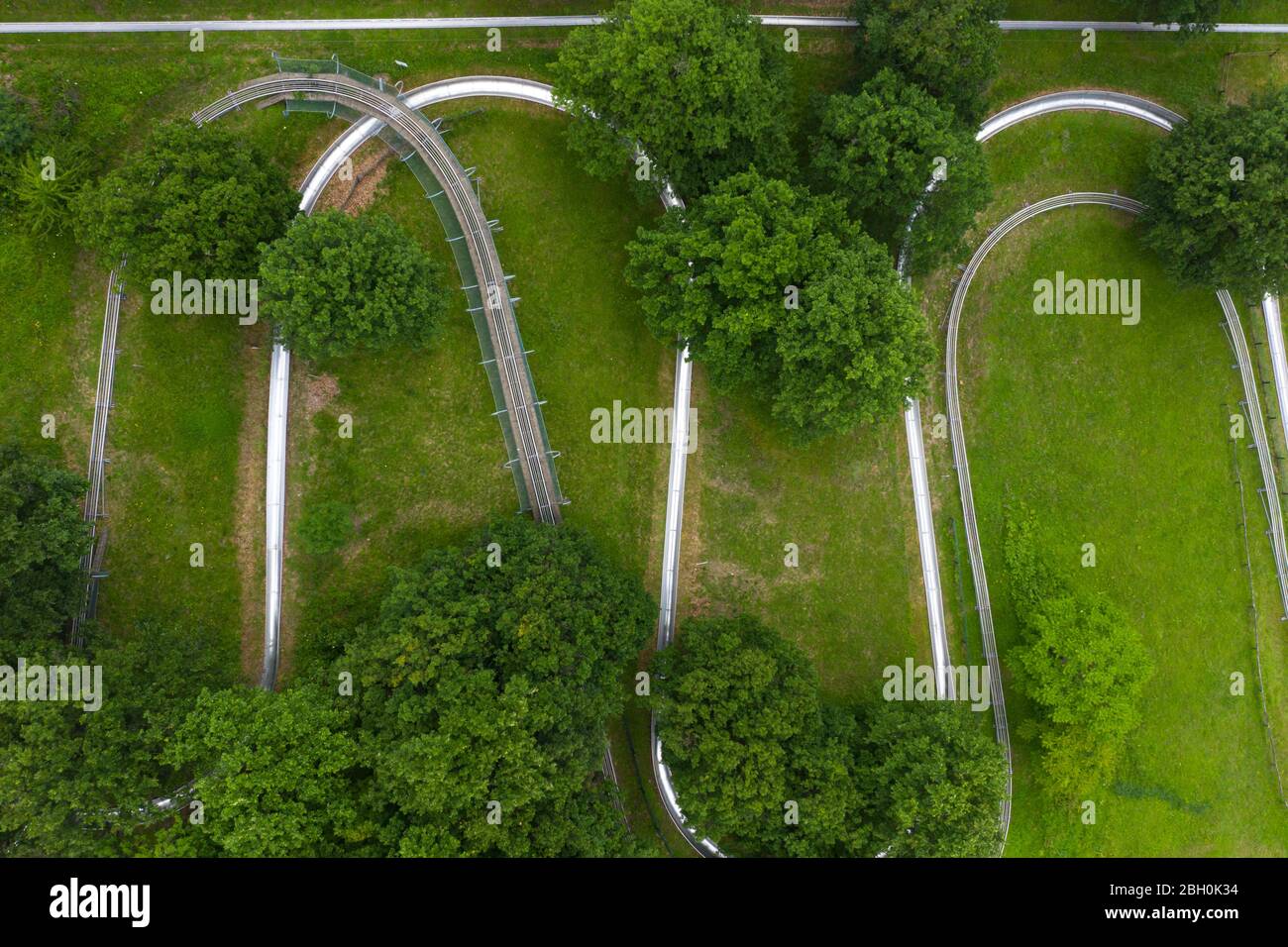 Aerial view of summer bob track in beautiful nature with green mountains in Visegrad, Hungary, Europe. Stock Photo