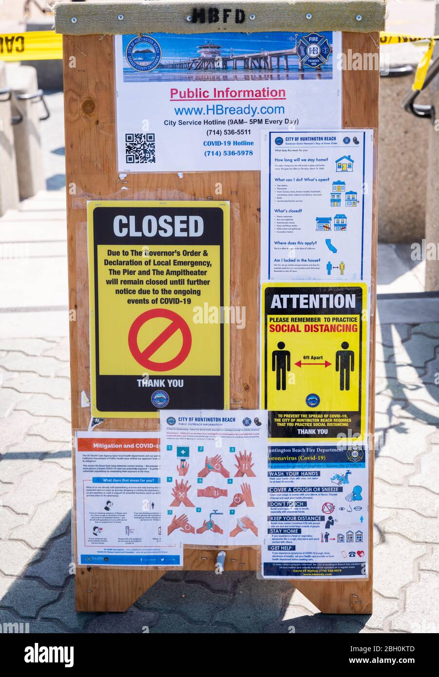 Public signs posted at the beach in Huntington Beach, California, regarding closures and health practices during the Covid-19 pandemic. Stock Photo
