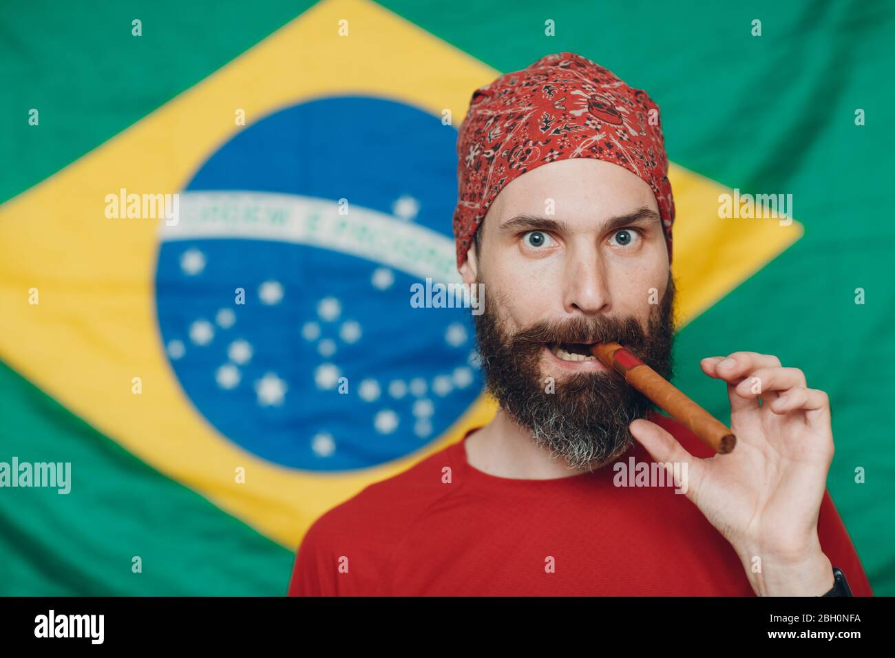 Bearded man in bandana against Brazilian flag background with cigar Stock  Photo - Alamy