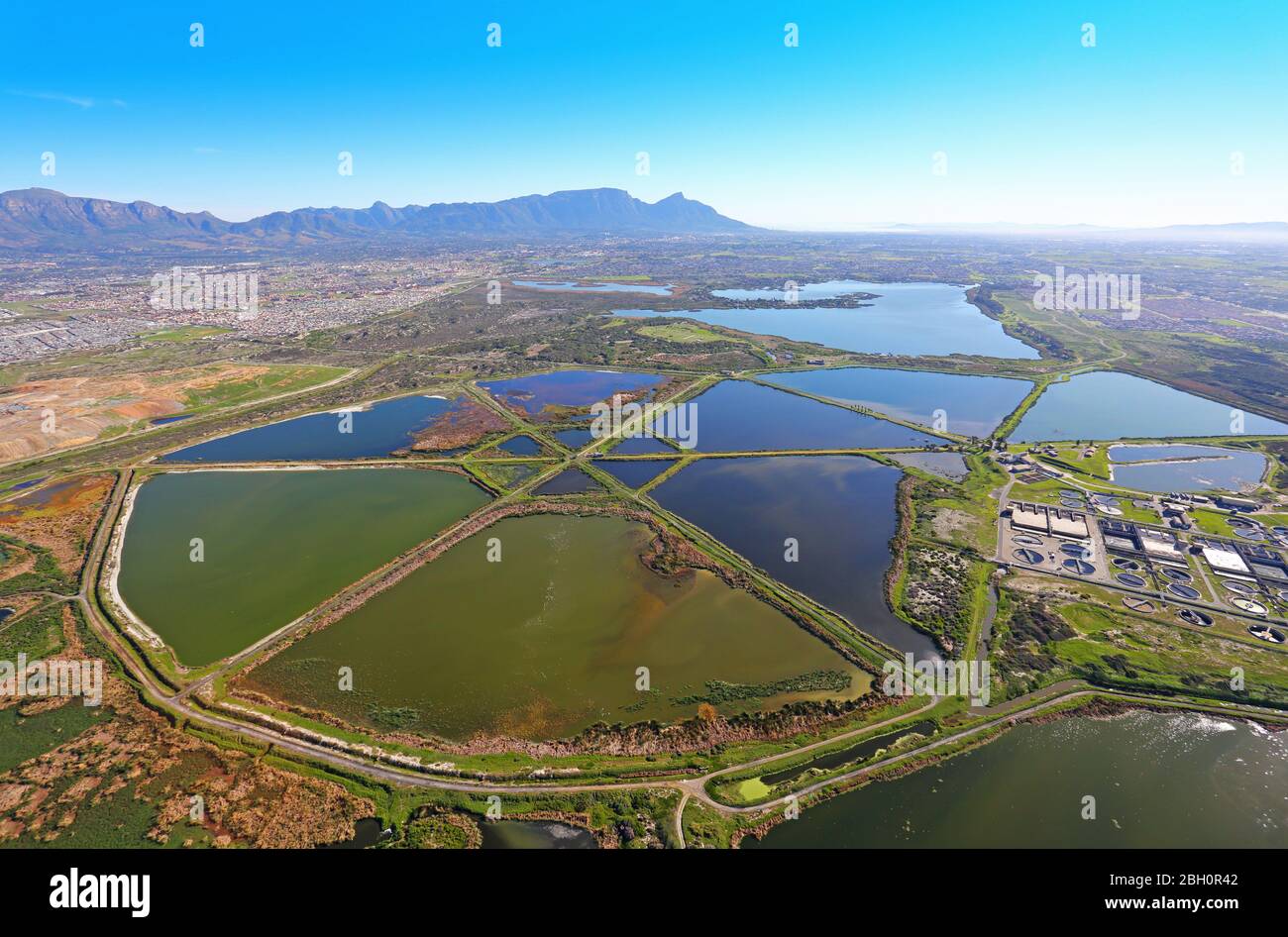Aerial photo of Cape Flats Water Waste Treatment Works with Table Mountain in the background Stock Photo