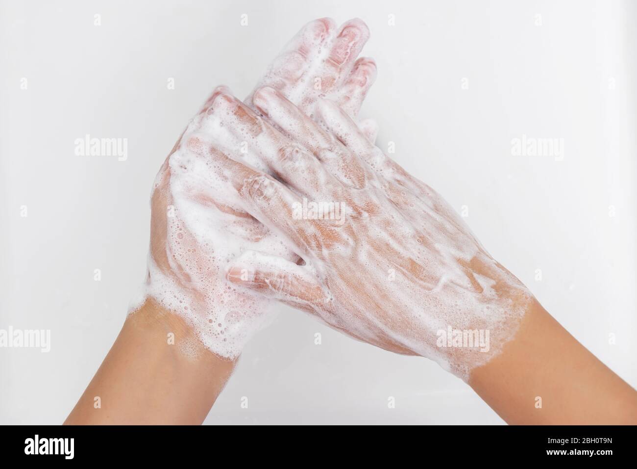 personal hygiene. washing hands, rubbing hand thoroughly with soap that has a lot of bubbles for cleaning and disinfection, prevention of spreading of Stock Photo