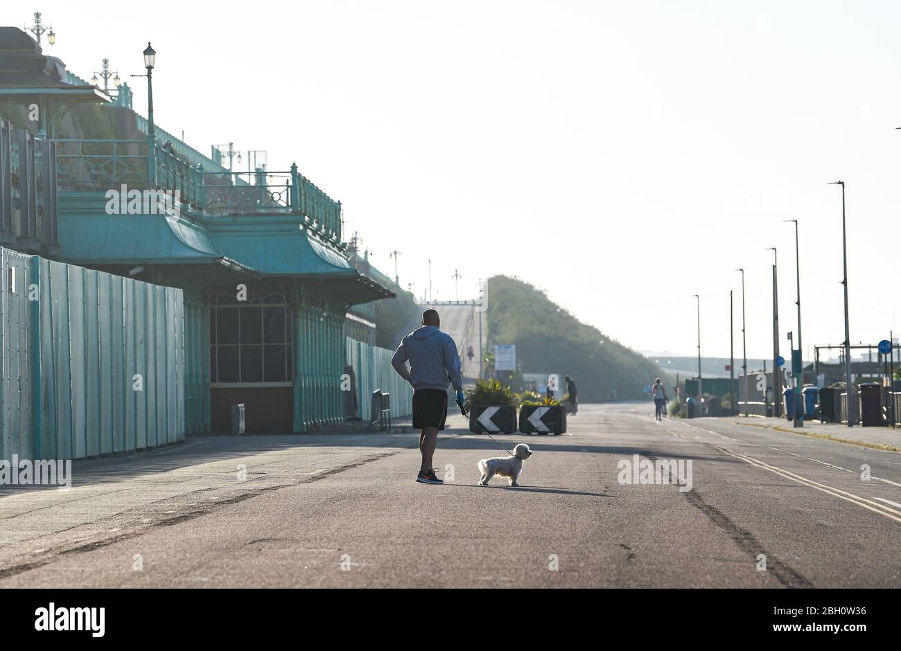 Brighton UK 23rd April 2020 - People taking exercise along Madeira Drive Brighton which is closed to traffic on a beautiful hot sunny day during the lockdown restrictions during the Coronavirus COVID-19 pandemic crisis  . Temperatures are expected to reach 25 degrees in some parts of the South East today .  Credit: Simon Dack / Alamy Live News Stock Photo
