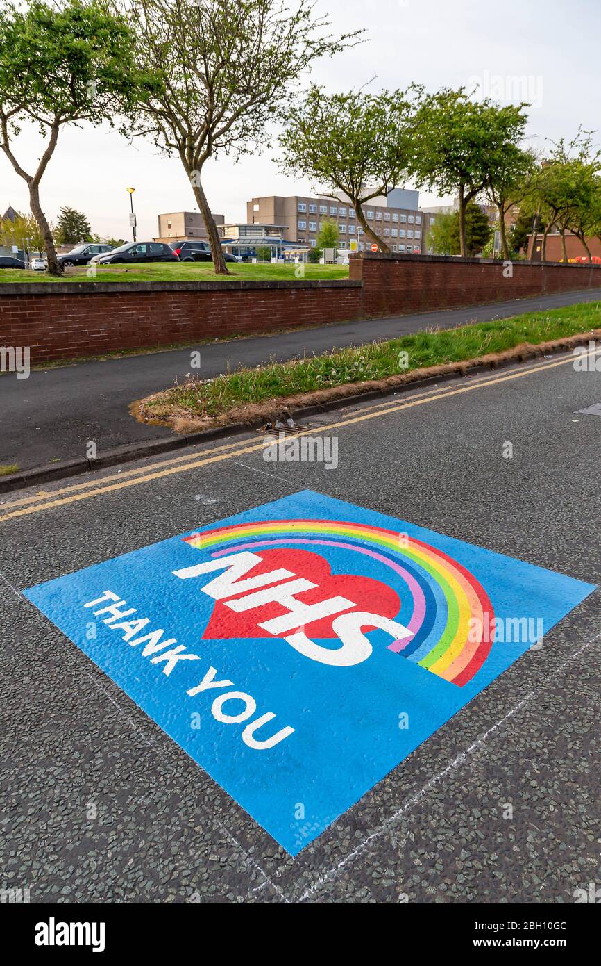 Warrington, Cheshire, UK. 23rd Apr 2020. Markings of gratitude and appreciation for the work that the NHS staff do have been painted on the road outside Warrington General Hospital in Lovely Lane. The two-metre-square messages read ‘NHS- Thank You' on a background of a heart and rainbow Credit: John Hopkins/Alamy Live News Credit: John Hopkins/Alamy Live News Stock Photo