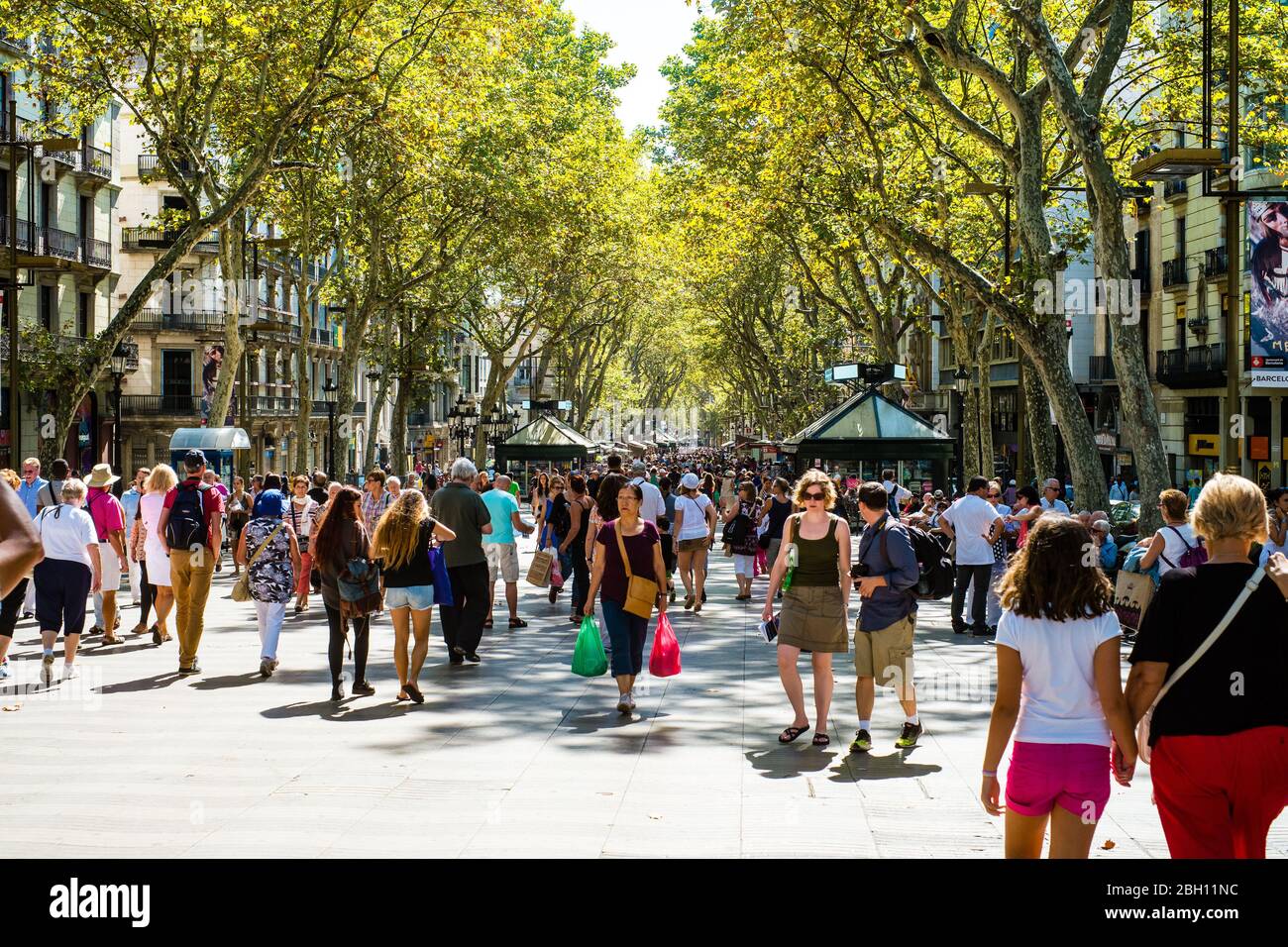 Shoppers and tourists mingle on Barcelonas famous La Rambla (Spain) Stock Photo