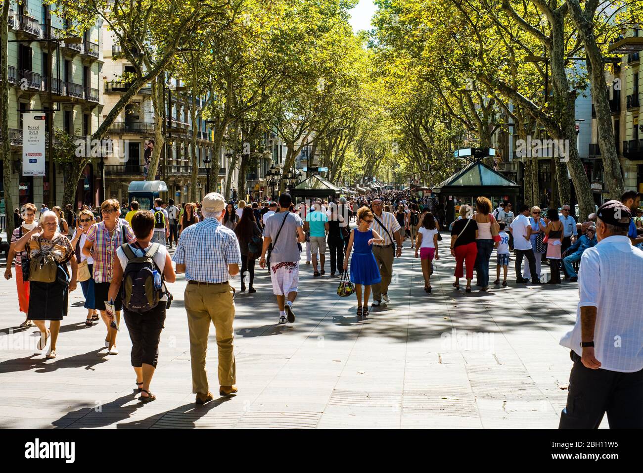 Shoppers and tourists mingle on Barcelonas famous La Rambla (Spain) Stock Photo