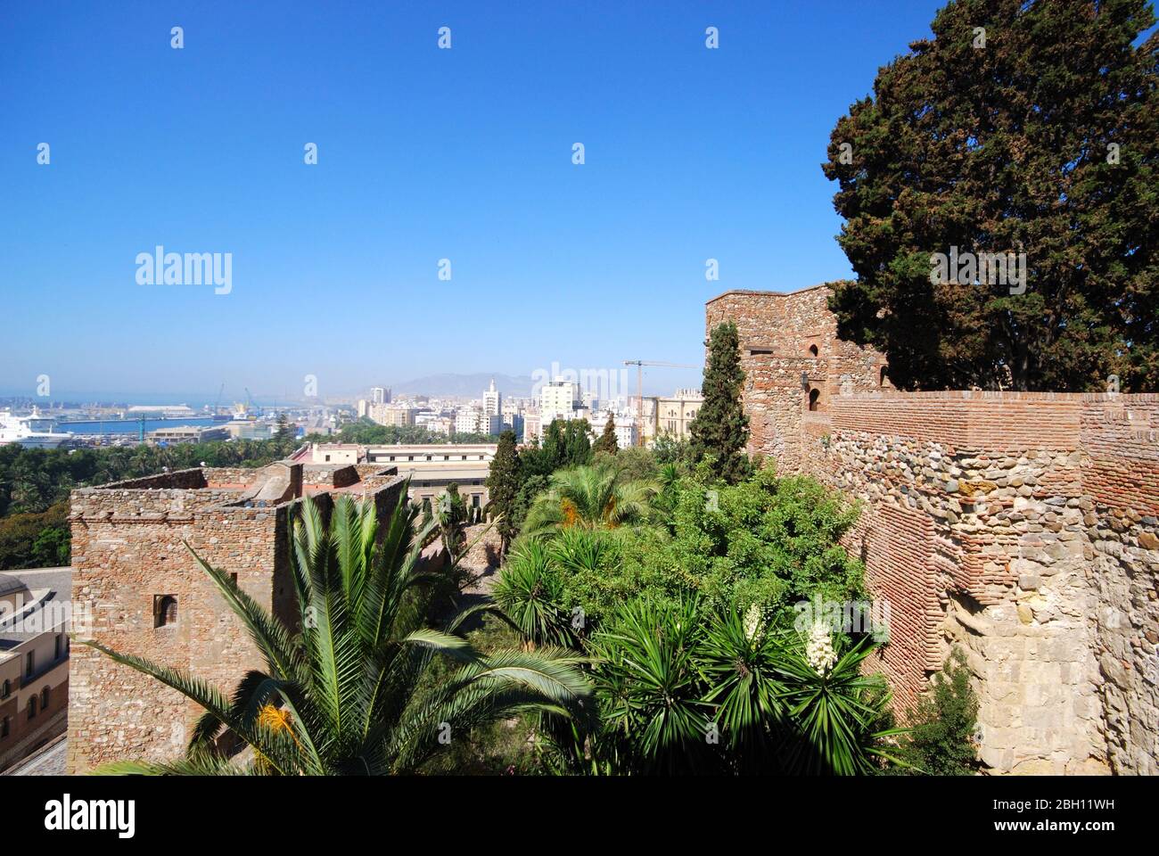 Elevated harbour view with the Christs Gate of Malaga castle in the foreground, Malaga, Malaga Province, Andalucia, Spain. Stock Photo