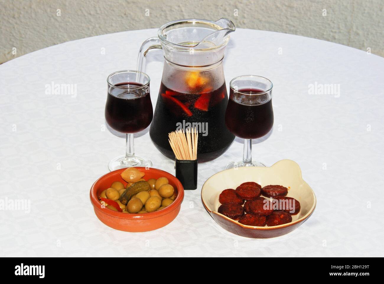 A selection of tapas with a jug of Sangria, Sliced Chorizo sausage and green olive cocktail, Costa del Sol, Malaga Province, Andalucia, Spain, Western Stock Photo