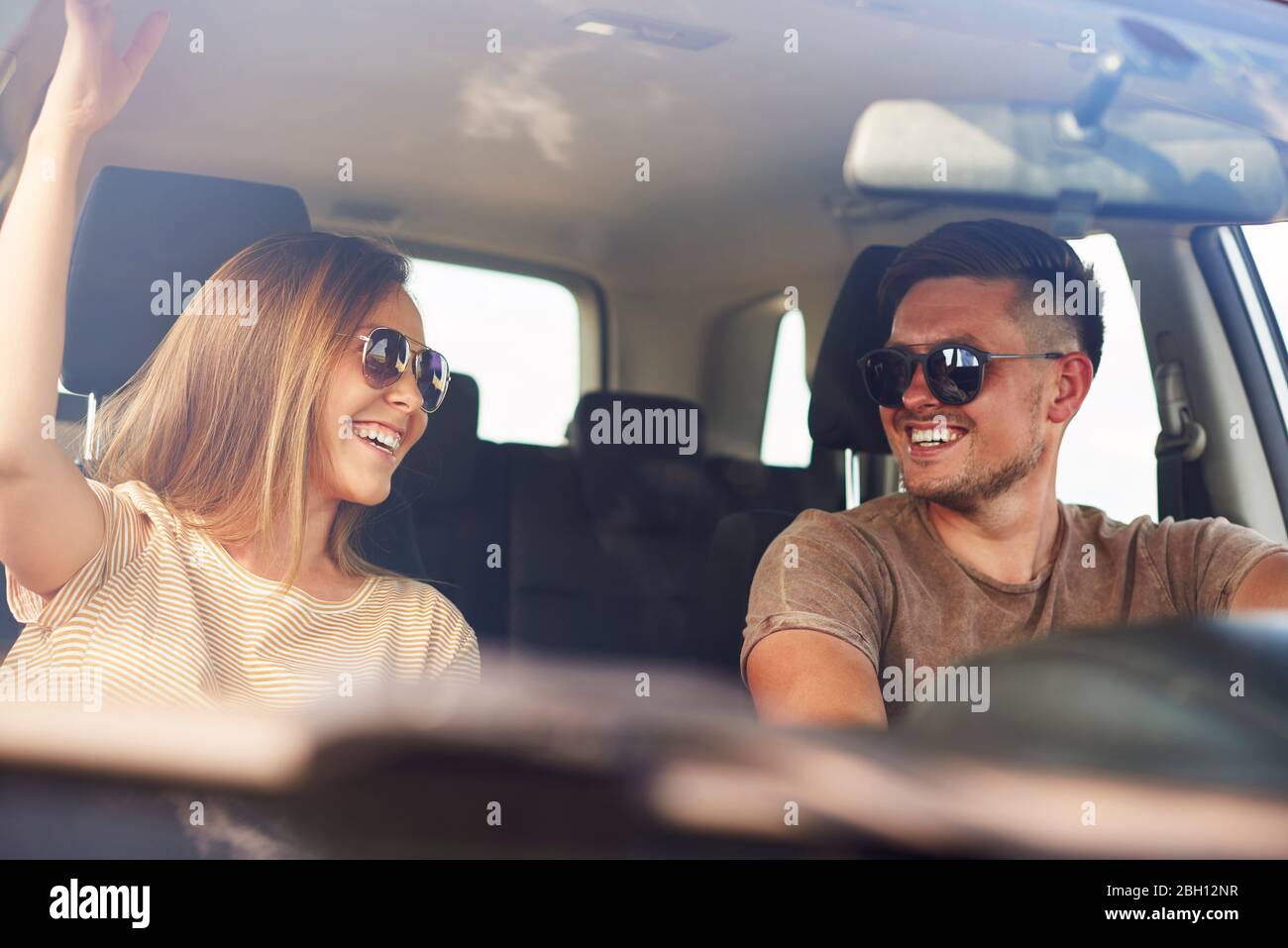 Smiling young couple in a car Stock Photo