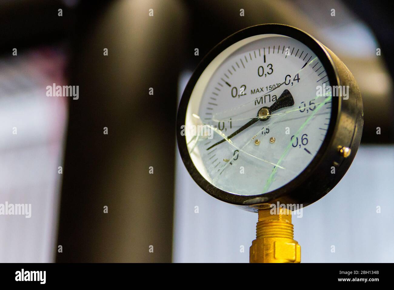 Industrial equipment with broken glass pressure gauge meters. Selective
