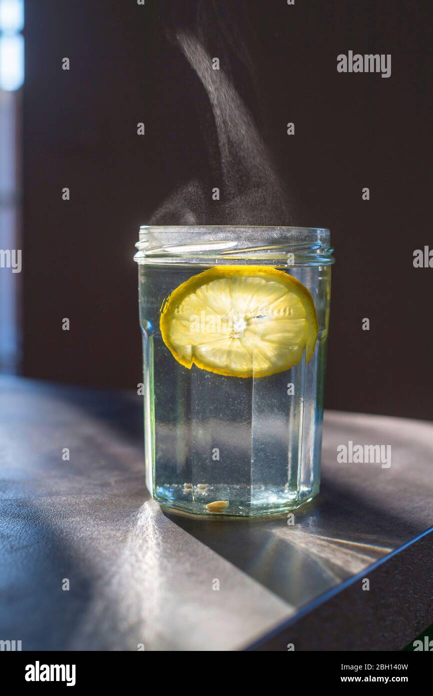 glass with hot water and slices of lemon Stock Photo