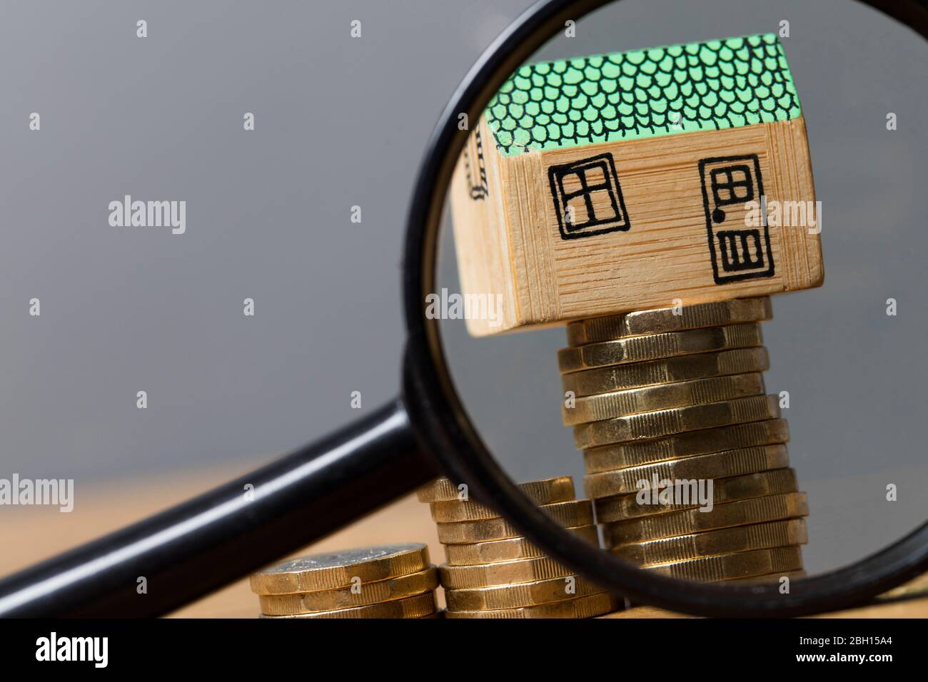 House model with magnifying glass. Property search concept Stock Photo