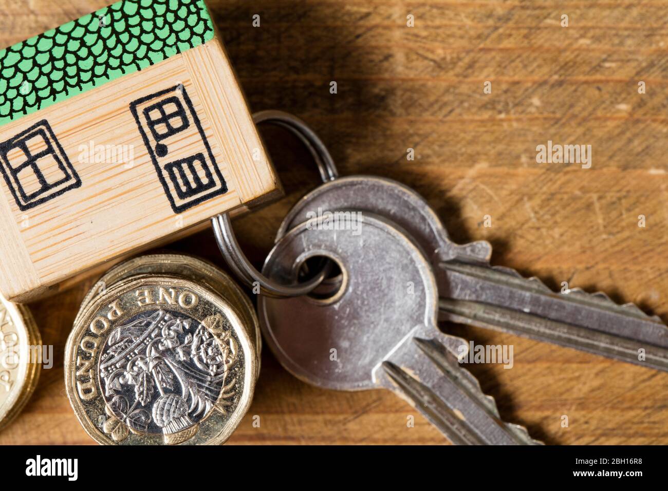Housing concept. Model house with set of home keys and coins Stock Photo