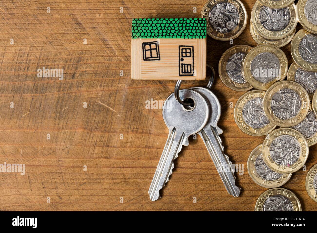 Housing concept. Model house with set of home keys and coins Stock Photo