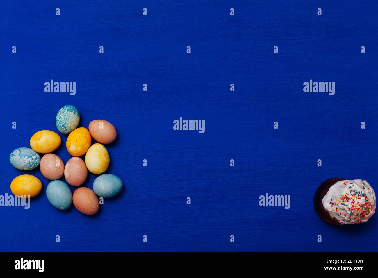 multi-colored eggs for the Easter holiday on a blue background Stock Photo