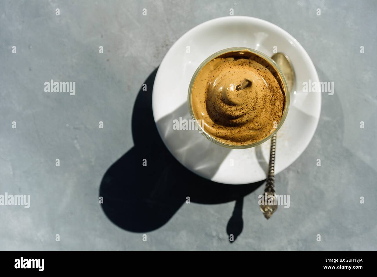 Dalgona instant coffee whipped drink with chocolate powder on top in