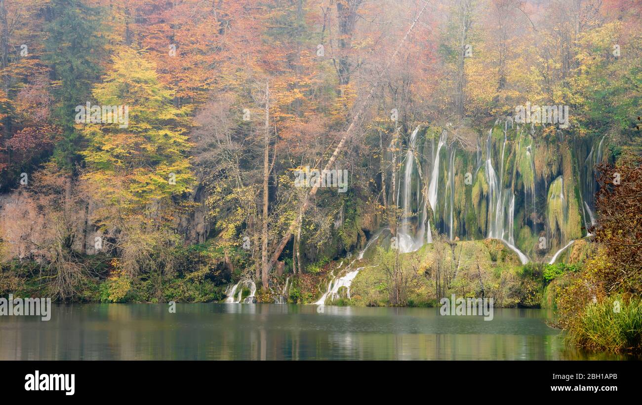 Small waterfalls sorrounded by trees with beautiful autumn colors in the Plitvice Lakes National Park, Croatia Stock Photo