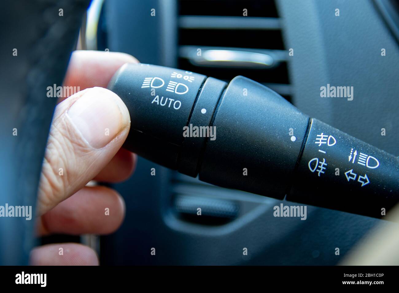 https://c8.alamy.com/comp/2BH1C0P/a-hand-on-an-indicator-stick-in-the-interior-of-a-car-also-used-to-turn-on-headlights-2BH1C0P.jpg