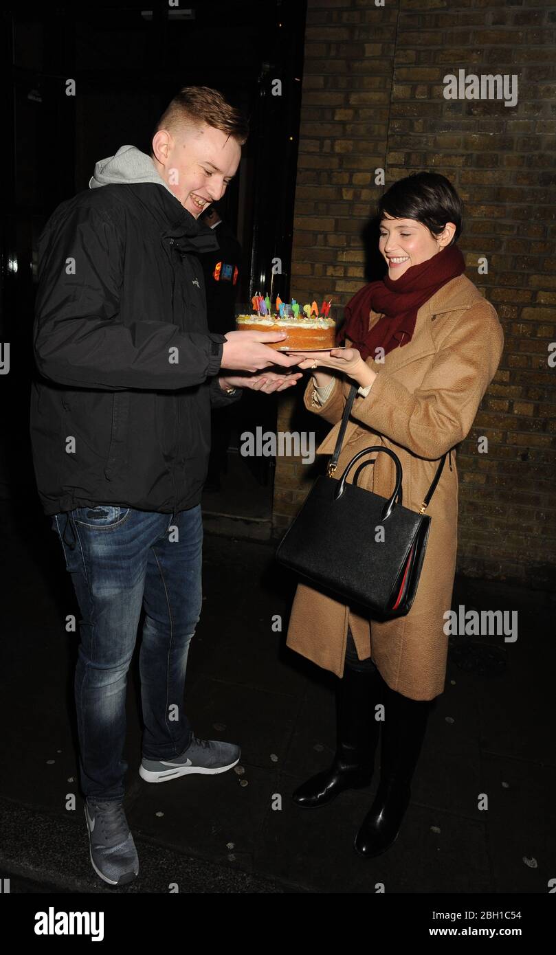 Gemma Arterton Leaves the Donmar Theatre in London where she is Starring in  Saint Joan and was greeted by a fan who presented her with a Birthday Cake  as it is her