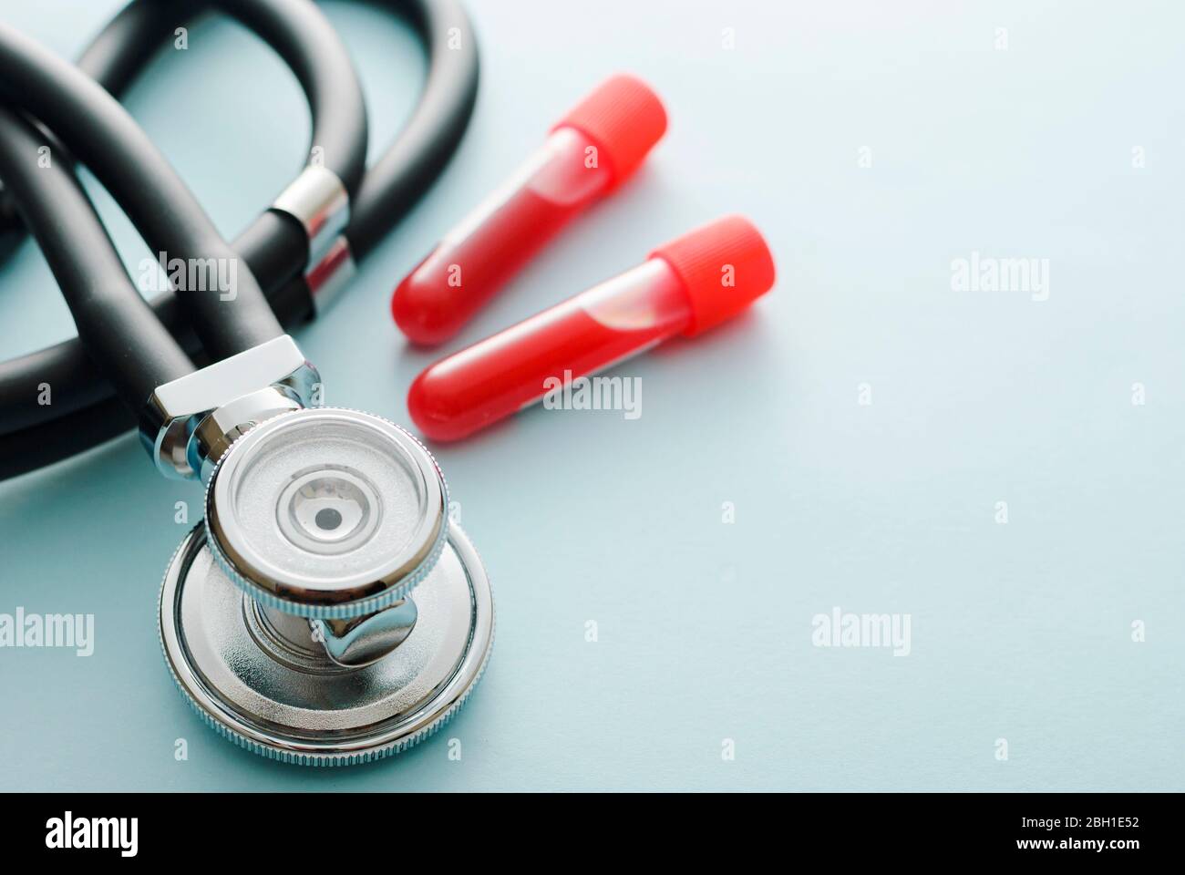 Lab test tubes with blood samples and stethoscope in a concept of diagnosis for the coronavirus or Covid-19 during the pandemic, medicine and healthca Stock Photo