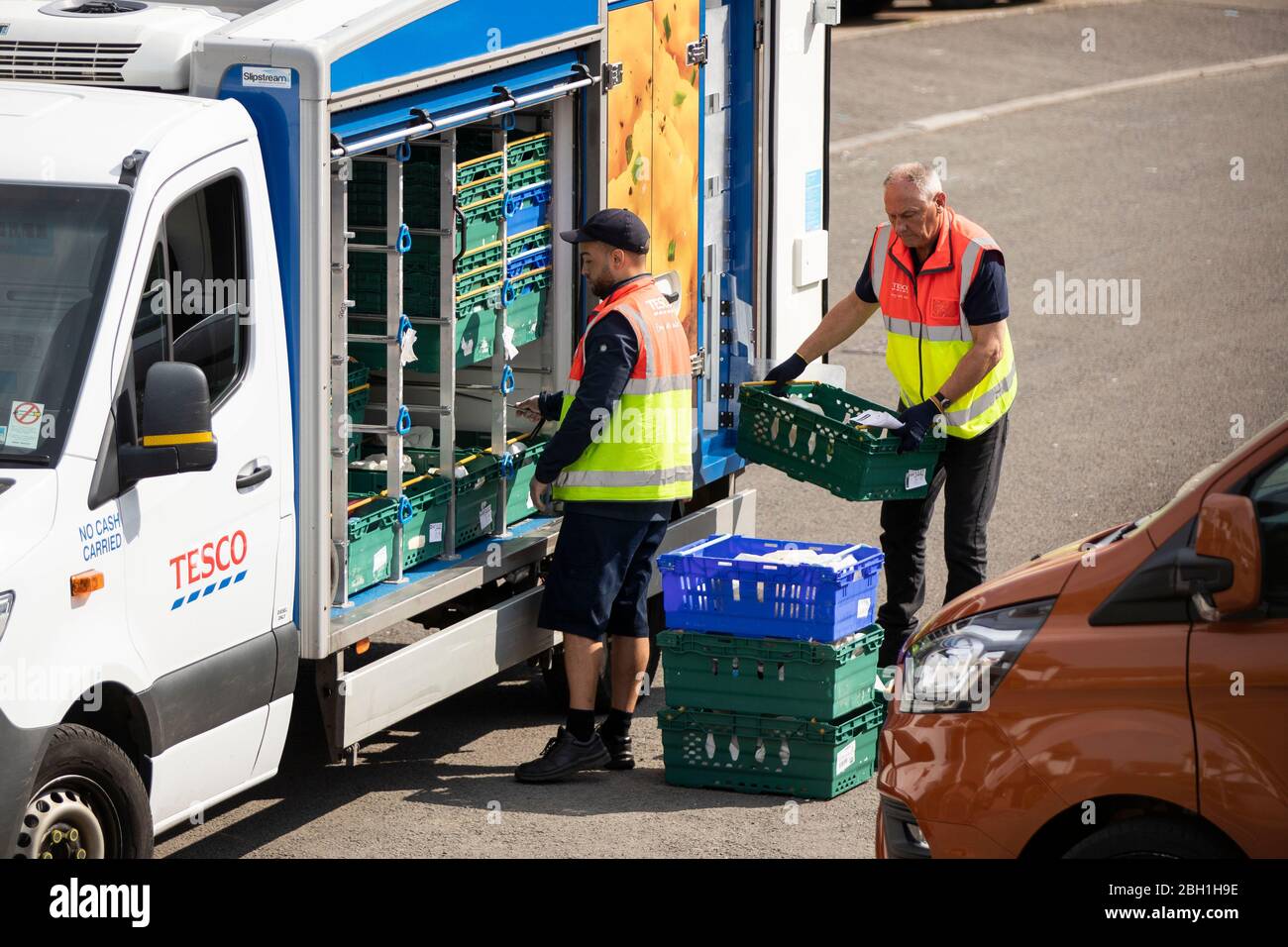 Tesco home delivery workers unload crates of food in Cardiff, April 2020 Stock Photo Alamy