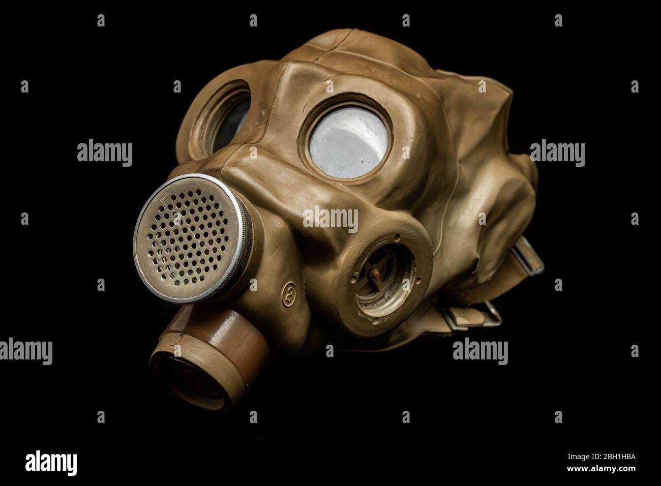A vintage military gas mask ventilator. Rubber material, glass eye holes,  on black Stock Photo - Alamy