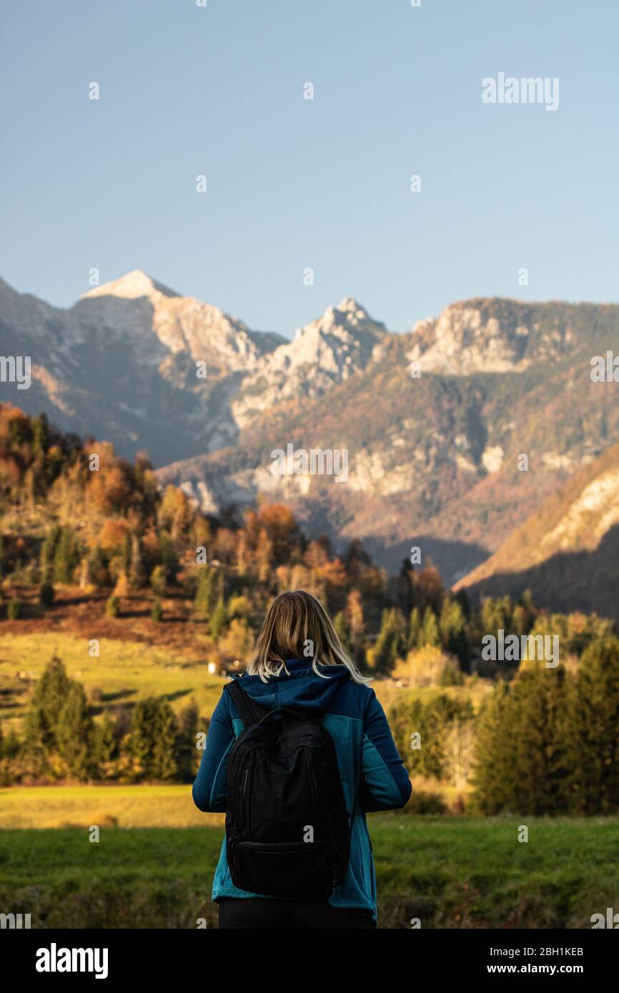 Hiking young woman with alps mountains on background Stock Photo - Alamy