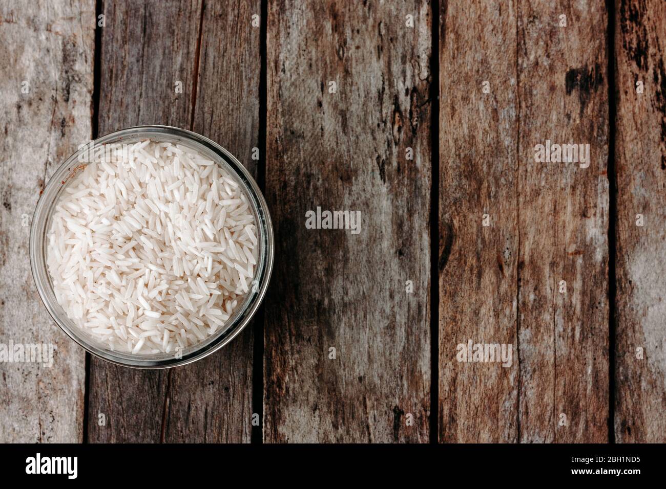 Rice in a glass jar on wooden table. Ingredients for italian risotto. Top view, space for text Stock Photo