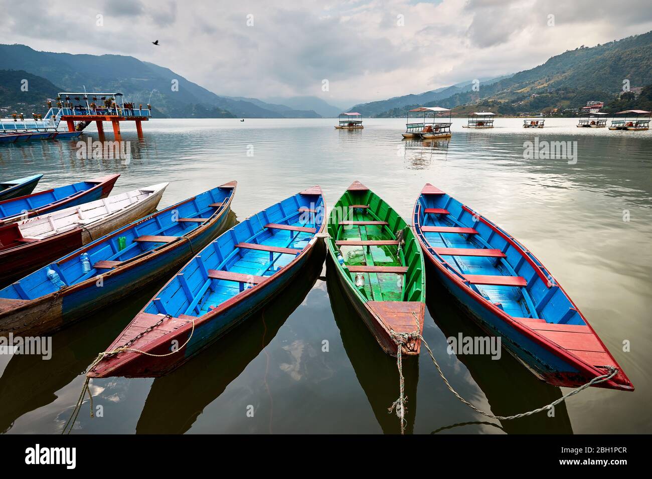 Color boats at Phewa lake shore in Pokhara, Nepal. Stock Photo