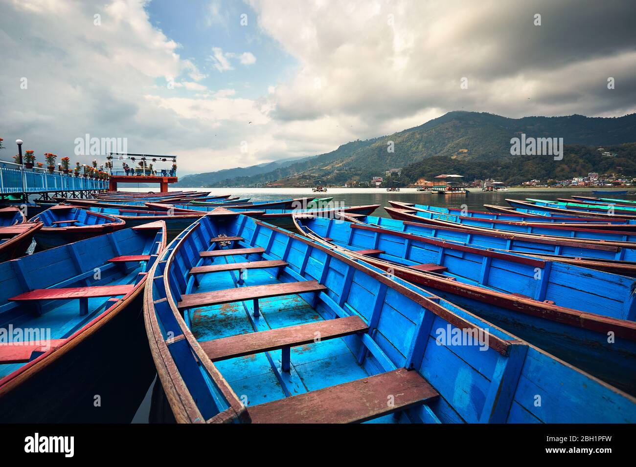 Blue boats at Phewa lake shore in Pokhara, Nepal. Stock Photo